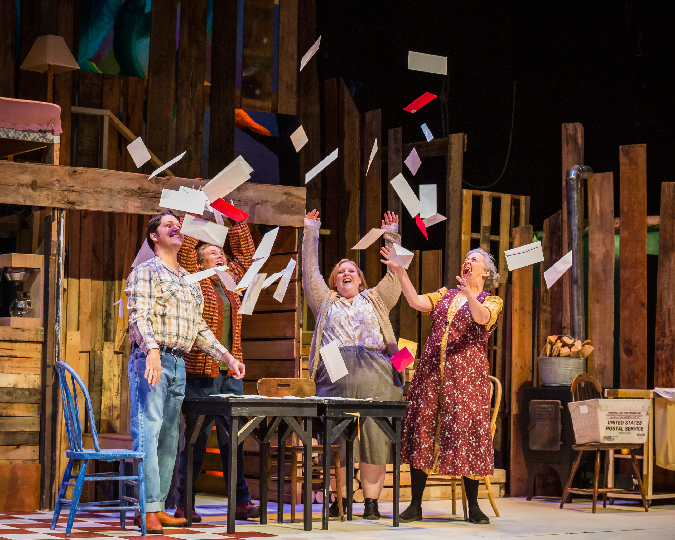 Actors on stage throwing mail in air