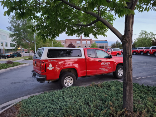 red truck with the Cosmic Crisp Apple Logo decal on it.